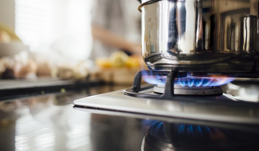 A pot sits on a gas stovetop. (File Photo credit: DGLimages via Shutterstock)