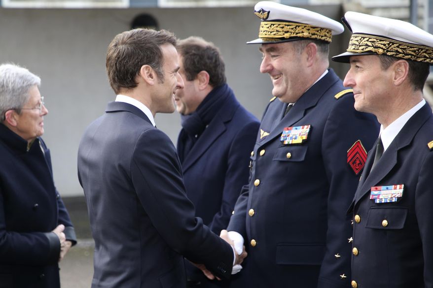 French President Emmanuel Macron shakes hands with Gen. Stephane Mille, second right, before his New Year address to the French Army, Friday, Jan. 20, 2023 at the Mont-de-Marsan air base, southwestern France. President Emmanuel Macron is expected to unveil his vision for modernizing the military in his nuclear-armed country, taking into account the impact of the war in Ukraine and evolving threats around the world. (AP Photo/Bob Edme, Pool)