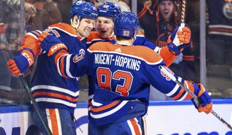 Edmonton Oilers&#39; Warren Foegele (37), Ryan Nugent-Hopkins (93) and Zach Hyman (18) celebrate a goal against the Tampa Bay Lightning during the second period of an NHL hockey game Thursday, Jan. 19, 2023, in Edmonton, Alberta. (Jason Franson/The Canadian Press via AP)