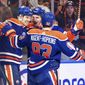 Edmonton Oilers&#x27; Warren Foegele (37), Ryan Nugent-Hopkins (93) and Zach Hyman (18) celebrate a goal against the Tampa Bay Lightning during the second period of an NHL hockey game Thursday, Jan. 19, 2023, in Edmonton, Alberta. (Jason Franson/The Canadian Press via AP)