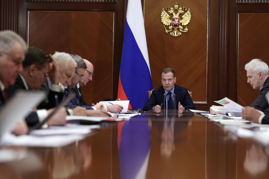 Deputy chairman of Russia's Security Council Dmitry Medvedev, center, chairs a meeting of the Presidium of the Presidential Council for Science and Education at Gorki state residence, outside Moscow, Russia, Friday, Jan. 20, 2023. (Ekaterina Shtukina/Sputnik Pool Photo via AP)