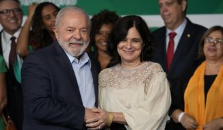 Brazilian President-elect Luiz Inacio Lula da Silva stands with his Health Minister Nisia Trindade during an event where he announced those who will lead ministries in his upcoming government in Brasilia, Brazil, Thursday, Dec. 22, 2022. Lula will be sworn-in on Jan. 1, 2023. (AP Photo/Eraldo Peres)