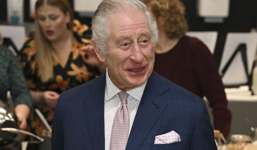 Britain's King Charles III visits the kitchen inside the headquarters of cereal manufacturer Kellogg's marking its 100th anniversary in Manchester, England, Friday Jan. 20, 2023. (Paul Ellis/Pool via AP)