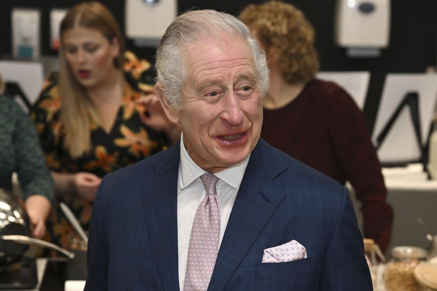 Britain's King Charles III visits the kitchen inside the headquarters of cereal manufacturer Kellogg's marking its 100th anniversary in Manchester, England, Friday Jan. 20, 2023. (Paul Ellis/Pool via AP)