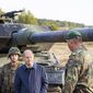 German Chancellor Olaf Scholz talks to German army Bundeswehr soldiers at a &quot;Leopard 2&quot; main battle tank during a training and instruction exercise in in Ostenholz, Germany, Monday, Oct. 17, 2022. Germany has become one of Ukraine&#39;s leading weapons suppliers in the 11 months since Russia&#39;s invasion. The debate among allies about the merits of sending battle tanks to Ukraine has focused the spotlight relentlessly on Germany, whose Leopard 2 tank is used by many other countries and has long been sought by Kyiv. (Moritz Frankenberg/dpa via AP, File)