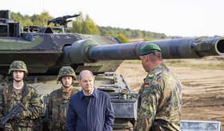 German Chancellor Olaf Scholz talks to German army Bundeswehr soldiers at a &quot;Leopard 2&quot; main battle tank during a training and instruction exercise in in Ostenholz, Germany, Monday, Oct. 17, 2022. Germany has become one of Ukraine&#x27;s leading weapons suppliers in the 11 months since Russia&#x27;s invasion. The debate among allies about the merits of sending battle tanks to Ukraine has focused the spotlight relentlessly on Germany, whose Leopard 2 tank is used by many other countries and has long been sought by Kyiv. (Moritz Frankenberg/dpa via AP, File)