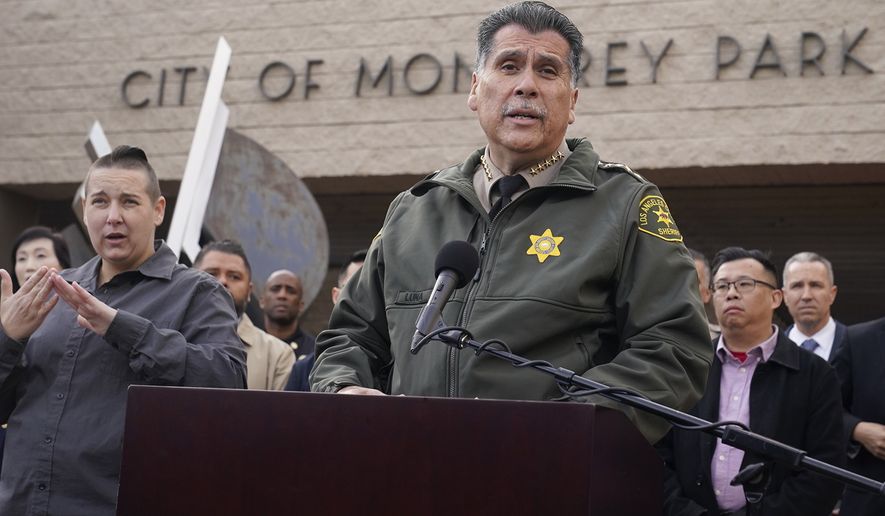 Los Angeles County Sheriff Robert Luna, at podium, briefs the media outside the Civic Center in Monterey Park, Calif., Sunday, Jan. 22, 2023. Monterey Park Mayor Henry Lo, second from right. A mass shooting at a Los Angeles-area ballroom dance club following a Lunar New Year celebration, set off a manhunt for the suspect. (AP Photo/Damian Dovarganes)