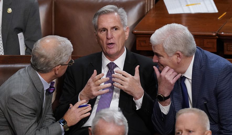 Rep. Patrick McHenry, R-N.C., left, and Rep. Tom Emmer, R-Minn., right, speaks with Rep. Kevin McCarthy, R-Calif., in the House chamber as the House meets for a second day to elect a speaker and convene the 118th Congress in Washington, Jan. 4, 2023. (AP Photo/Alex Brandon, File)