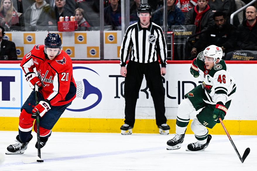 Washington Capitals center Lars Eller (20) keeps the puck in the offensive zone against the Minnesota Wild at Capital One Arena, Washington, D.C., January 17, 2023. (Photo by Brian Murphy)