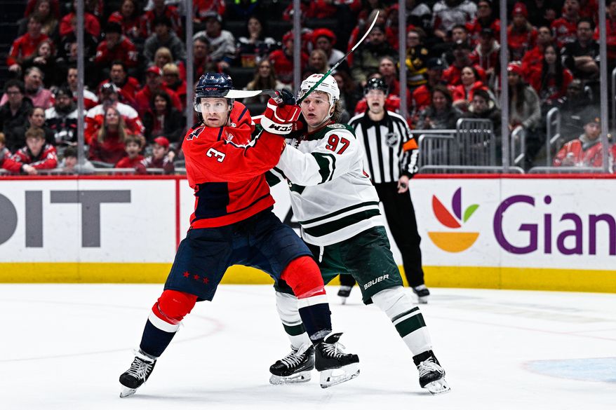 Washington Capitals defenseman Nick Jensen (3) battles Minnesota Wild forward Kirill Kaprizov (97) for position at Capital One Arena, Washington, D.C., January 17, 2023. (Photo by Brian Murphy)