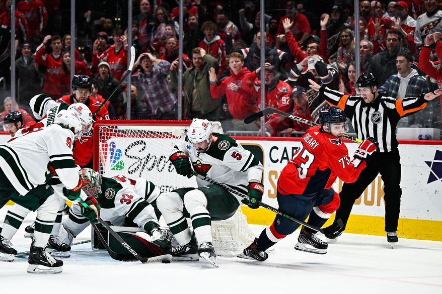Washington Capitals forward Conor Sheary (73) spins around in an attempt to locate the loose puck against the Minnesota Wild at Capital One Arena, Washington, D.C., January 17, 2023. (Photo by Brian Murphy)