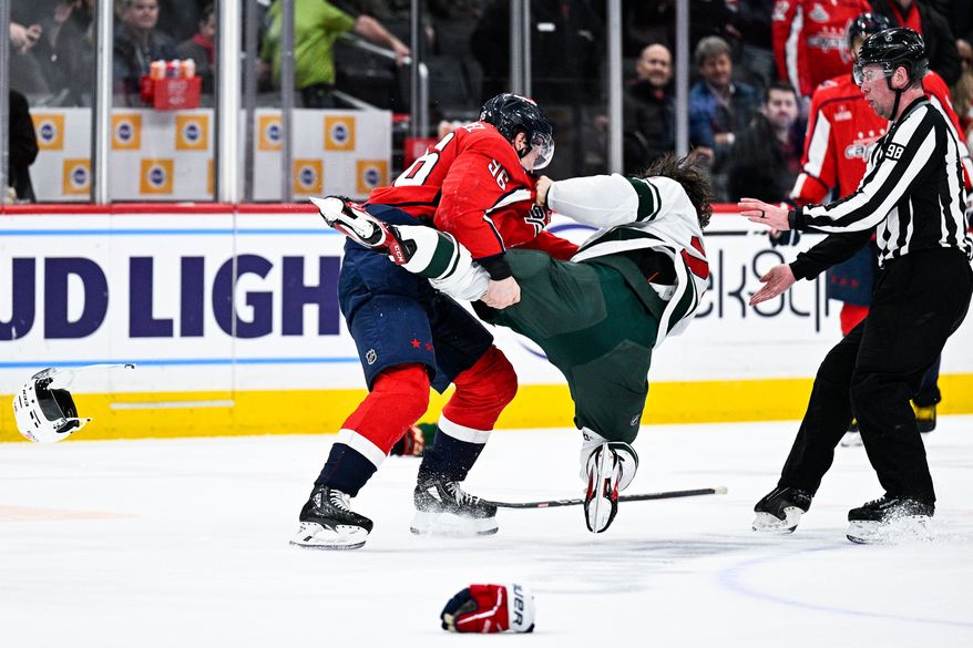 Washington Capitals right wing Nicolas Aube-Kubel (96) drops the gloves and slams Minnesota Wild forward Brandon Duhaime (21) to the ice at Capital One Arena, Washington, D.C., January 17, 2023. (Photo by Brian Murphy)