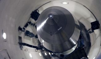 An inert Minuteman III missile is seen in a training launch tube at Minot Air Force Base, N.D., June 25, 2014. Nine military officers who had worked decades ago at a nuclear missile base in Montana, home to a vast field of 150 Minuteman III intercontinental ballistic missile silos, have been diagnosed with blood cancer and there are “indications” the disease may be linked to their service, according to military briefing slides obtained by The Associated Press. One of the officers has died. (AP Photo/Charlie Riedel, File)