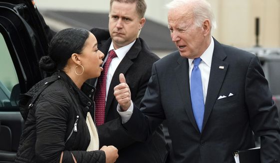 President Joe Biden talks with Ashley Williams, Special Assistant to the President and Deputy Director of Oval Office Operations, as he arrives to board Air Force One at Dover Air Force Base, in Dover, Del., on Monday, Jan. 23, 2023, en route to Washington. (AP Photo/Carolyn Kaster)