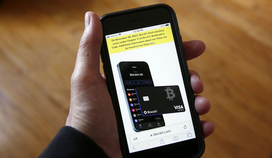 Text, in yellow, announcing cryptocurrency lender BlockFi&#39;s bankruptcy filing, appears on the company&#39;s website on a smartphone, Nov. 28, 2022, in New York. Over the past few years, a number of companies have attempted to act as the cryptocurrency equivalent of a bank, promising lucrative returns to customers who deposited their bitcoin or other digital assets. In a span of less than 12 months, nearly all of the biggest of those companies have failed spectacularly. (AP Photo/Peter Morgan, File)