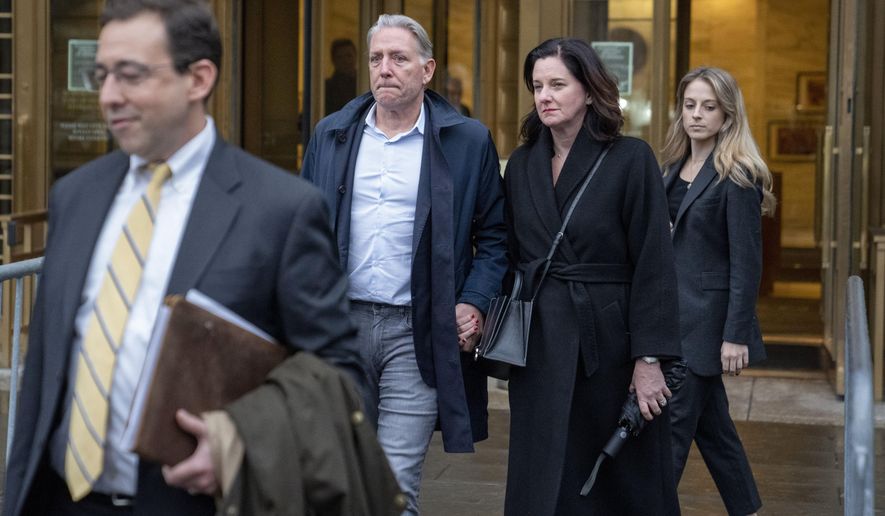 Charles McGonigal, center left, former special agent in charge of the FBI&#x27;s counterintelligence division in New York, leaves court, Monday, Jan. 23, 2023, in New York. The former high-ranking FBI counterintelligence official has been indicted on charges he helped a Russian oligarch, in violation of U.S. sanctions. (AP Photo/John Minchillo)