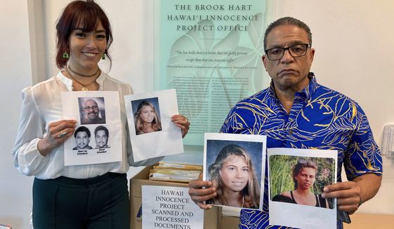 University of Hawaii law school student Skye Jansen, left, and Hawaii Innocence Project co-director Kenneth Lawson pose with photos related to the 1991 murder of Dana Ireland in Honolulu on Tuesday, Jan. 17, 2023. A petition filed Monday, Jan. 23 outlining new evidence in one of Hawaii&#39;s biggest criminal cases asks a judge to release Albert “Ian” Schweitzer, a Native Hawaiian man who has spent more than 20 years in prison for the sexual assault, kidnapping and murder of Ireland, a white woman, on the Big Island.  (AP Photo/Jennifer Sinco Kelleher)