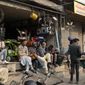 Shopkeepers and workers wait for electric power at a market following a power breakdown across the country, in Lahore, Pakistan, Monday, Jan. 23, 2023. Much of Pakistan was left without power for several hours on Monday morning as an energy-saving measure by the government backfired. The outage spread panic and raised questions about the cash-strapped government’s handling of the crisis. (AP Photo/K.M. Chaudary)