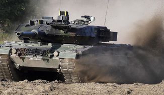 A Leopard 2 tank is pictured during a demonstration event held for the media by the German Bundeswehr in Munster near Hannover, Germany, Wednesday, Sept. 28, 2011. Poland will apply to the German government for permission to supply the German-made Leopard battle tanks to Ukraine. (AP Photo/Michael Sohn, File)