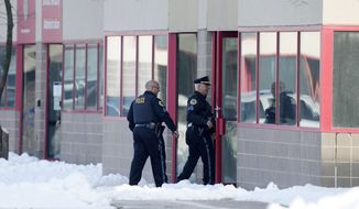 Law enforcement officers enter the Starts Right Here building, Monday, Jan. 23, 2023, in Des Moines, Iowa. Police say two students were killed and a teacher was injured in a shooting at the Des Moines school on the edge of the city&#39;s downtown. (AP Photo/Charlie Neibergall)