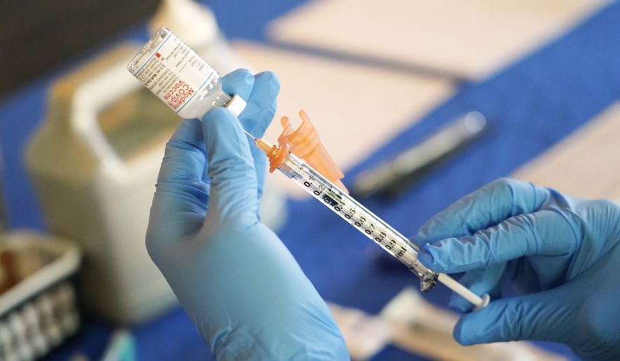 A nurse prepares a syringe of a COVID-19 vaccine at an inoculation station in Jackson, Miss., July 19, 2022. U.S. health officials are proposing a simplified approach to COVID-19 vaccinations, which would allow most adults and children to get a once-a-year shot to protect against the mutating virus. The new system unveiled Monday, Jan. 23, 2023 would make COVID-19 inoculations more like the annual flu shot. (AP Photo/Rogelio V. Solis, File)