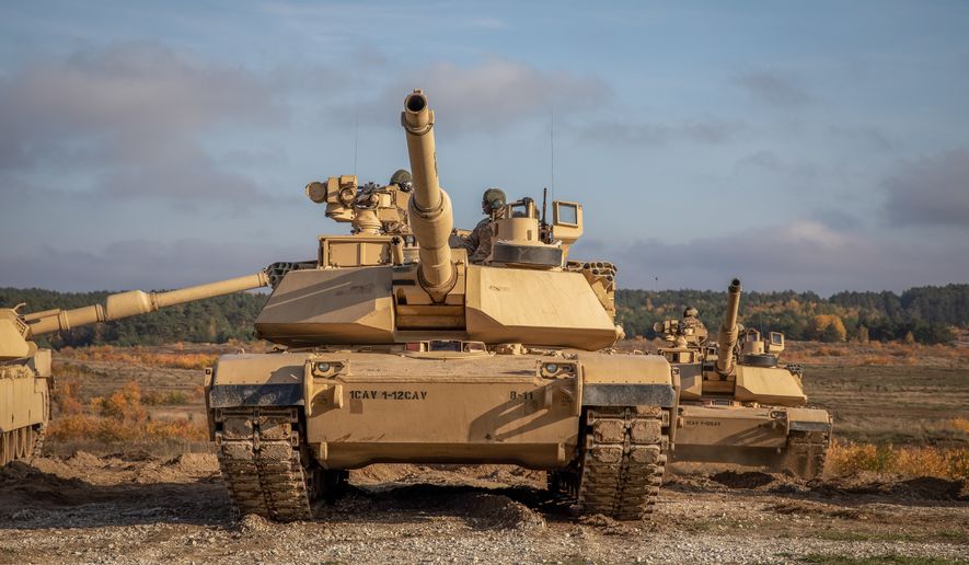 Polish soldiers assigned to the 11th Armored Lubuska Cavalry Division gather around the recently removed Abrams M1A2 System Enhancement Package version 3 tanks power pack during the Abrams Logistical Summit at Drawsko Pomorskie, Poland, Oct. 27, 2022. The 3-1 ABCT is proudly working alongside 1st Infantry Division, other NATO allies and regional security partners to provide combat-credible forces to V Corps, America&#39;s forward deployed corps in Europe. (U.S. Army National Guard photo by Spc. Kevin T. Brown Jr.)