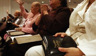 Susana Hernandez of New York (partially seen at right) holding a Spanish Holy Bible as she and others take part in a Spanish Easter service at the Primitive Christian Church in New York on Sunday, April 12, 2009. A small but growing number of Latinos are turning to Protestant denominations, particularly Pentecostal and Evangelical, finding the worship styles and Hispanic pulpit leadership can be a better fit for their spiritual needs. (AP Photo/Tina Fineberg) **FILE**