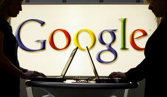 In this April 17, 2007, file photo, exhibitors work on laptop computers in front of an illuminated sign of the Google logo at the industrial fair Hannover Messe in Hanover, Germany. (AP Photo/Jens Meyer, File)
