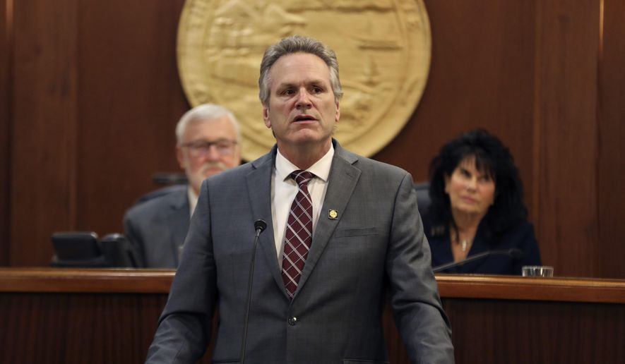 Alaska Gov. Mike Dunleavy delivers the first State of the State speech of his second term in office before a joint session of the Alaska Legislature on Monday, Jan. 23, 2023, in Juneau, Alaska. Shown behind him are Senate President Gary Stevens, left, and House Speaker Cathy Tilton, right. (Clarise Larson/The Juneau Empire via AP)