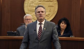 Alaska Gov. Mike Dunleavy delivers the first State of the State speech of his second term in office before a joint session of the Alaska Legislature on Monday, Jan. 23, 2023, in Juneau, Alaska. Shown behind him are Senate President Gary Stevens, left, and House Speaker Cathy Tilton, right. (Clarise Larson/The Juneau Empire via AP)