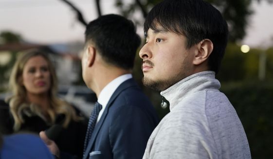 Brandon Tsay, 26, right, and his father, Tom Tsay, make a statement outside their home on Monday, Jan. 23, 2023, in San Marino, Calif. Brandon Tsay disarmed a gunman who killed multiple people late Saturday amid Lunar New Years celebrations in the predominantly Asian American community of Monterey Park. The gunman started at the Star Ballroom Dance Studio in Monterey Park and continued to Lai Lai Ballroom and Studio in Alhambra, where he was disarmed by Tsay. (AP Photo/Ashley Landis)