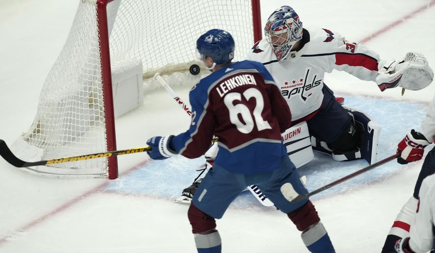 Colorado Avalanche left wing Artturi Lehkonen, front, looks on as his shot sails past Washington Capitals goaltender Darcy Kuemper for a goal in the first period of an NHL hockey game Tuesday, Jan. 24, 2023, in Denver. (AP Photo/David Zalubowski)