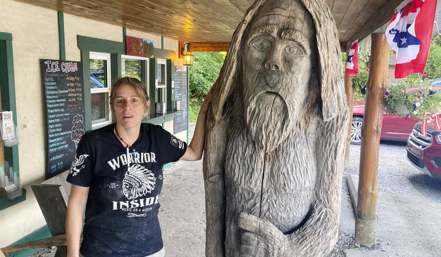Pauline Bauer leans against a wooden statue outside Bob&#39;s Trading Post, her restaurant in Hamilton, Pa., July 21, 2021. A federal judge has convicted a Bauer of storming the U.S. Capitol, where she screamed at police officers to bring out then-House Speaker Nancy Pelosi so the pro-Trump mob could hang her. (AP Photo/Michael Kunzelman)