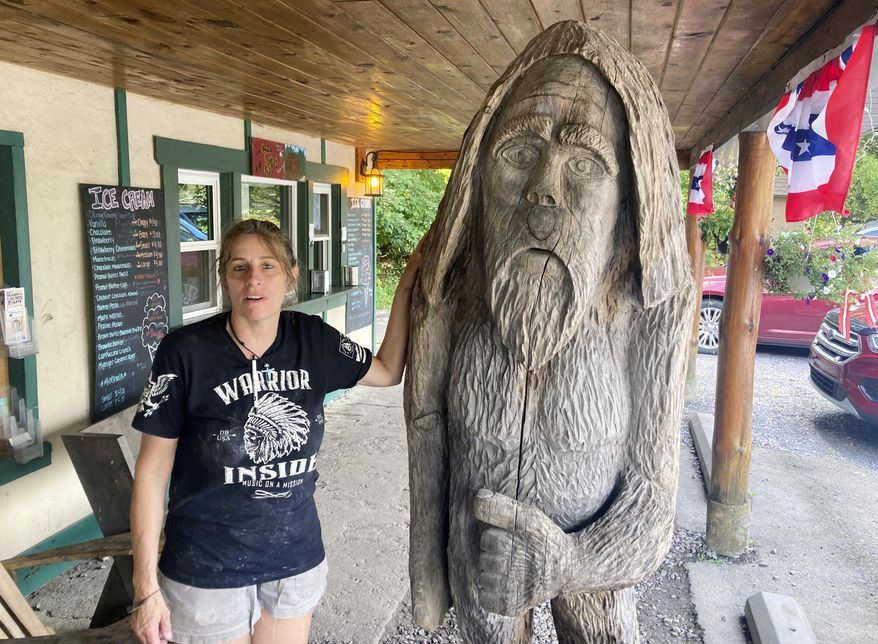 Pauline Bauer leans against a wooden statue outside Bob&#x27;s Trading Post, her restaurant in Hamilton, Pa., July 21, 2021. A federal judge has convicted a Bauer of storming the U.S. Capitol, where she screamed at police officers to bring out then-House Speaker Nancy Pelosi so the pro-Trump mob could hang her. (AP Photo/Michael Kunzelman)