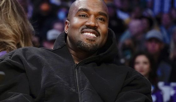 Kanye West, known as Ye, watches the first half of an NBA basketball game between the Washington Wizards and the Los Angeles Lakers in Los Angeles, on March 11, 2022. A senior Australian government minister said Wednesday, Jan. 25, 2023, that Ye, could be refused a visa due to antisemitic comments if he attempts to visit Australia. (AP Photo/Ashley Landis, File)