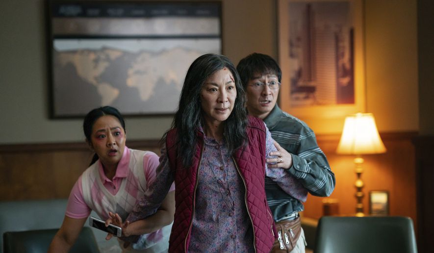 This image released by A24 Films shows, from left, Stephanie Hsu, Michelle Yeoh and Ke Huy Quan in a scene from, &quot;Everything Everywhere All At Once.&quot; (Allyson Riggs/A24 Films via AP)