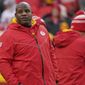 Kansas City Chiefs offensive coach Eric Bieniemy watches warms up prior prior to an NFL Divisional Playoff football game against the Jacksonville Jaguars Saturday, Jan. 21, 2023, in Kansas City, Mo. (AP Photo/Ed Zurga)