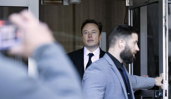 Elon Musk leaves the Phillip Burton Federal Building and United States Court House in San Francisco, Tuesday, Jan. 24, 2023. Musk returned to federal court to defend himself against a class-action lawsuit that alleges he misled Tesla shareholders with a tweet about an aborted buyout that the billionaire defiantly insisted Tuesday he could have pulled off, had he wanted. (AP Photo/ Benjamin Fanjoy)