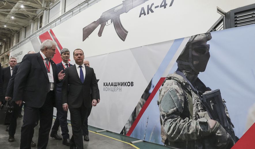 Deputy head of Russia&#39;s Security Council and chairman of the United Russia party Dmitry Medvedev, right, listens to General Director of the Kalashnikov Concern Vladimir Lepin, left, while visiting the Kalashnikov Group plant in Izhevsk, Russia, Tuesday, Jan. 24, 2023. Medvedev inspected samples of weapons and held a meeting with the working group of the military-industrial commission to control their production. (Ekaterina Shtukina, Sputnik Pool Photo via AP)