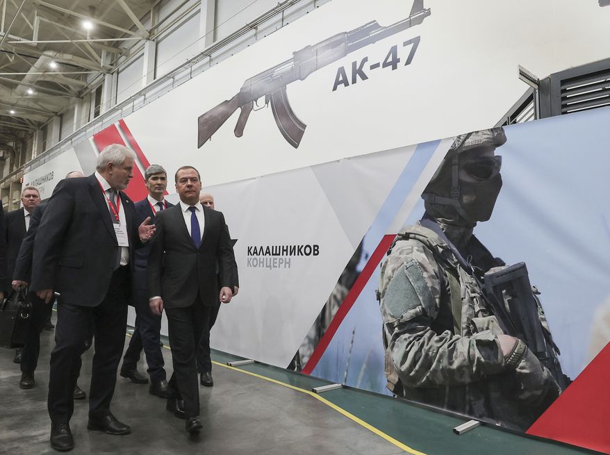 Deputy head of Russia&#39;s Security Council and chairman of the United Russia party Dmitry Medvedev, right, listens to General Director of the Kalashnikov Concern Vladimir Lepin, left, while visiting the Kalashnikov Group plant in Izhevsk, Russia, Tuesday, Jan. 24, 2023. Medvedev inspected samples of weapons and held a meeting with the working group of the military-industrial commission to control their production. (Ekaterina Shtukina, Sputnik Pool Photo via AP)