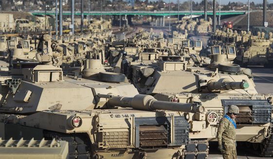 A soldier walks past a line of M1 Abrams tanks, Nov. 29, 2016, at Fort Carson in Colorado Springs, Colo. (Christian Murdock/The Gazette via AP, File)