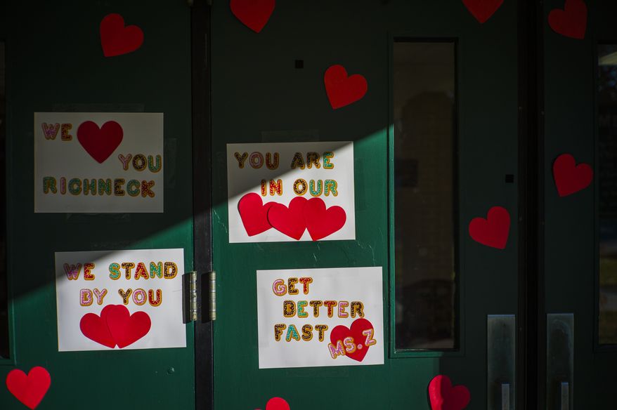Messages of support for teacher Abby Zwerner, who was shot by a 6-year-old student, grace the front door of Richneck Elementary School Newport News, Va., on Jan. 9, 2023. According to a Tuesday, Jan. 24, 2023, media advisory, the first-grade teacher from Virginia who was shot and seriously wounded by a 6-year-old student, has hired a trial attorney to represent her. (AP Photo/John C. Clark, File)