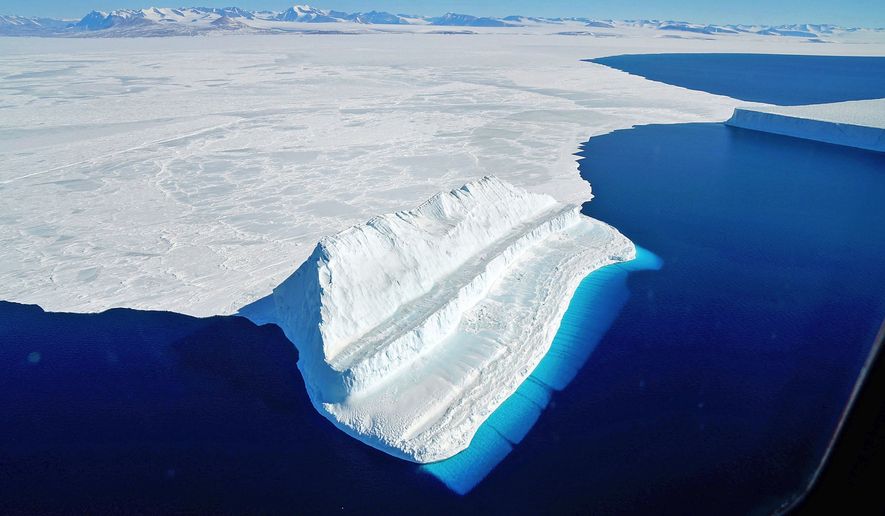 The frigid Antarctic region is an expanse of white ice and blue waters, as pictured in March 2017, at the U.S. research facility McMurdo Station. NASA&#39;s Operation IceBridge has collected annual measurements of Antarctic ice to track changes and help predict sea level rise. (Chris Larsen/NASA via AP) **FILE**