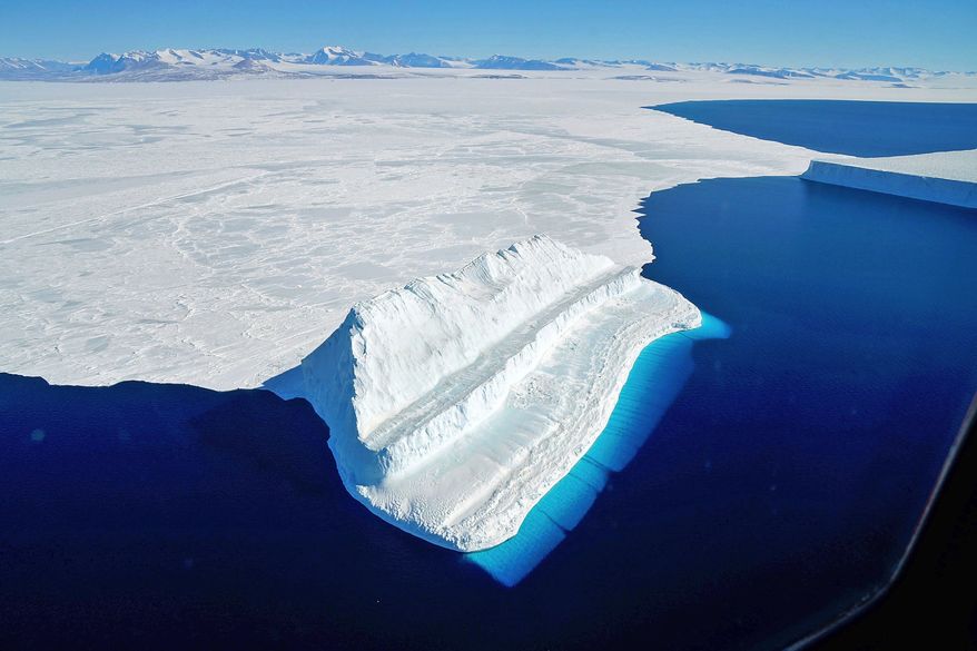 The frigid Antarctic region is an expanse of white ice and blue waters, as pictured in March 2017, at the U.S. research facility McMurdo Station. NASA&#x27;s Operation IceBridge has collected annual measurements of Antarctic ice to track changes and help predict sea level rise. (Chris Larsen/NASA via AP) **FILE**