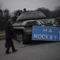 A man walks by a sign that reads &quot;to Moscow&quot; placed on an old tank displayed at a war museum in Kyiv, Ukraine, Wednesday, Jan. 25, 2023. (AP Photo/Daniel Cole)