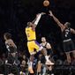 Los Angeles Lakers forward LeBron James (6) shoots as Los Angeles Clippers forward Kawhi Leonard (2) defends and guard Terance Mann (14), center Ivica Zubac (40) and center Thomas Bryant watch during the first half of an NBA basketball game Tuesday, Jan. 24, 2023, in Los Angeles. (AP Photo/Mark J. Terrill)