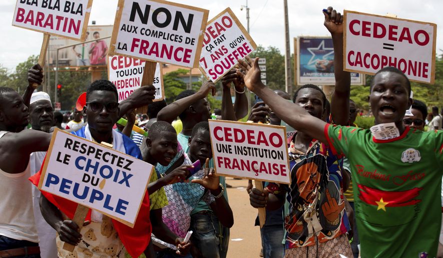 Supporters of Capt. Ibrahim Traore protest against France and the West African regional bloc known as ECOWAS in the streets of Ouagadougou, Burkina Faso, Tuesday, Oct. 4, 2022. France&#x27;s foreign ministry said Wednesday Jan.25, 2023 French troops in Burkina Faso will withdraw from the country within a month, after the junta government required such move _ following in the path of neighboring Mali. A top official at the foreign ministry said France has formally received from Burkina Faso a decision to terminate the 2018 agreement that was related to the presence of French troops in the country. (AP Photo/Kilaye Bationo, File)
