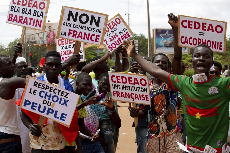 Supporters of Capt. Ibrahim Traore protest against France and the West African regional bloc known as ECOWAS in the streets of Ouagadougou, Burkina Faso, Tuesday, Oct. 4, 2022. France&#x27;s foreign ministry said Wednesday Jan.25, 2023 French troops in Burkina Faso will withdraw from the country within a month, after the junta government required such move _ following in the path of neighboring Mali. A top official at the foreign ministry said France has formally received from Burkina Faso a decision to terminate the 2018 agreement that was related to the presence of French troops in the country. (AP Photo/Kilaye Bationo, File)