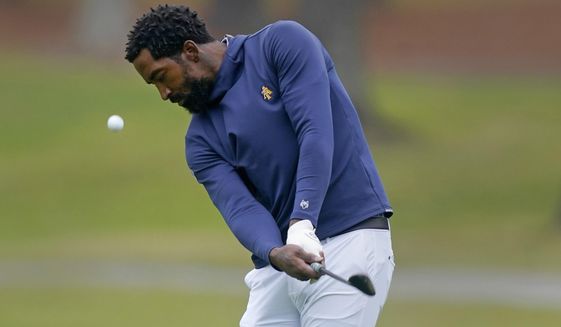North Carolina A&amp;T&#39;s J.R. Smith chips from the 17th fairway during the first round of the Phoenix Invitational golf tournament in Burlington, N.C., Oct. 11, 2021. Smith, a former NBA player, hopes his journey to become a college golfer helps others feel comfortable taking up the sport regardless of their background. Smith is part of a new video podcast launching Wednesday designed to make the sport more accessible to young and diverse audiences. (AP Photo/Gerry Broome, File)