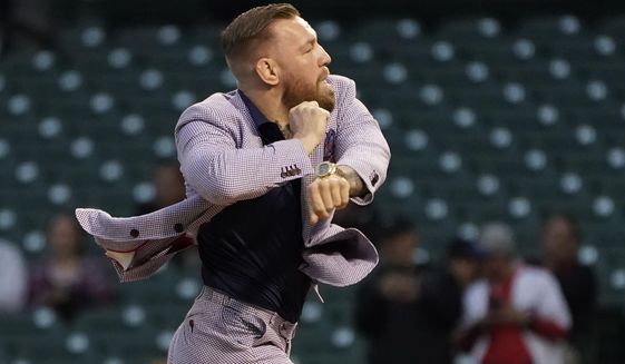 MMA fighter Conor McGregor throws out a ceremonial first pitch before a baseball game on Sept. 21, 2021, in Chicago. Conor McGregor is under investigation in Spain after being accused of physical assault in Ibiza, court officials said Wednesday, Jan. 25, 2023. The case had been closed but a judge ordered it to be reopened after receiving more details about what allegedly happened. (AP Photo/Charles Rex Arbogast) **FILE**
